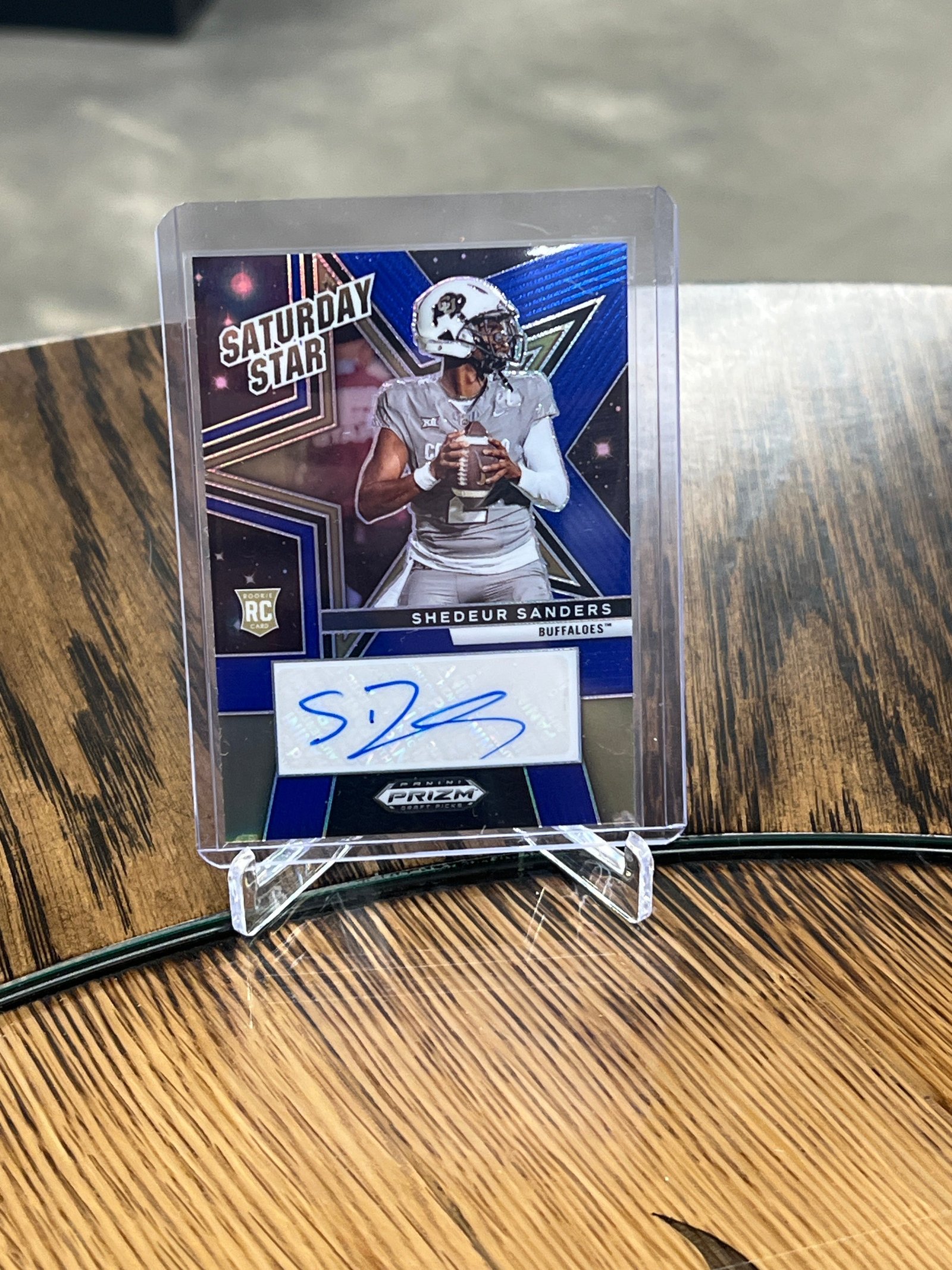 A9FFD22D-EF2C-4047-99AB-321F041F50B3 Shedeur Sanders 2025 Panini Prizm Draft Saturday Star Blue Prizm Auto #12/75 BROWNS JERSEY NUMBER - Image 1